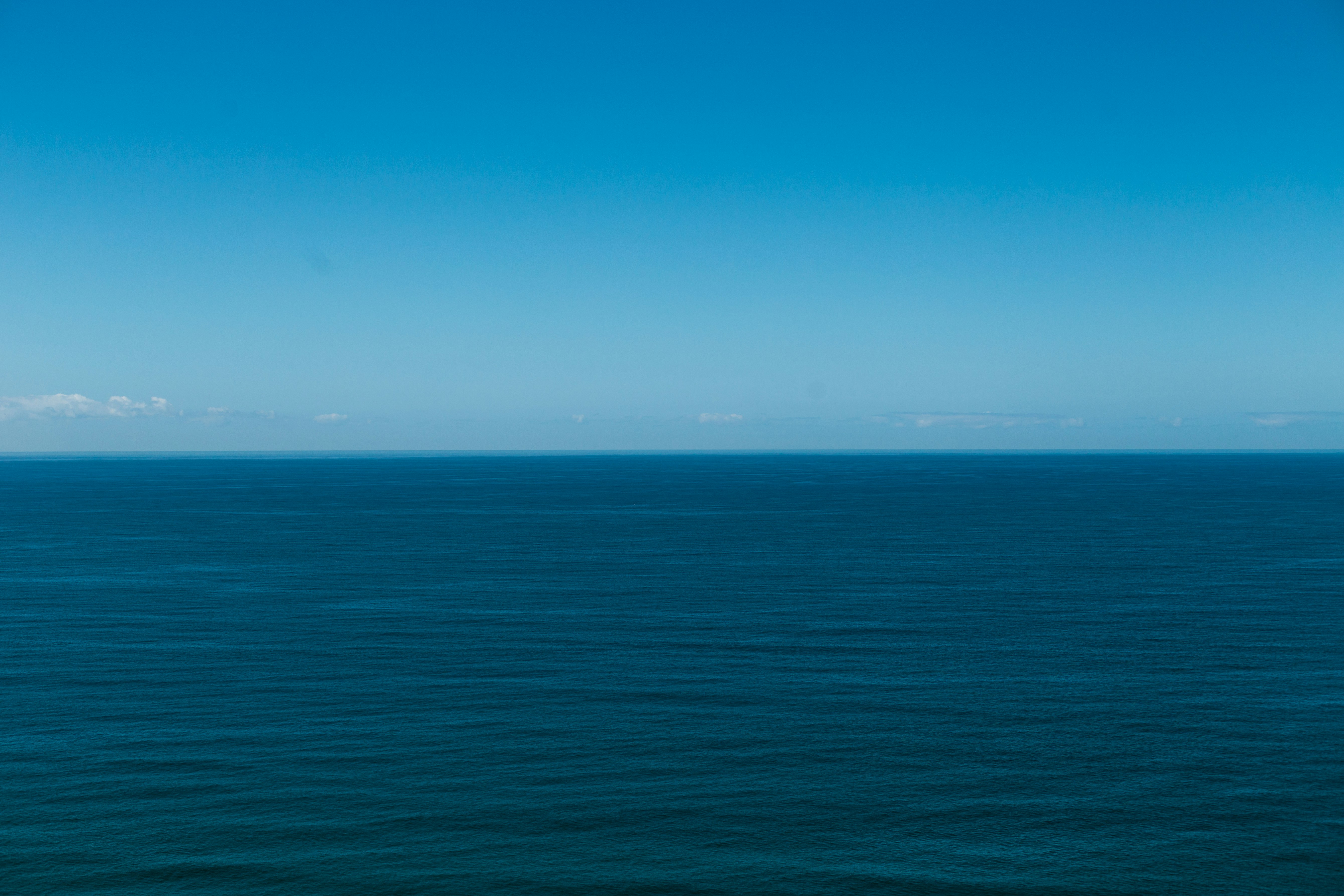 blue ocean under blue sky during daytime